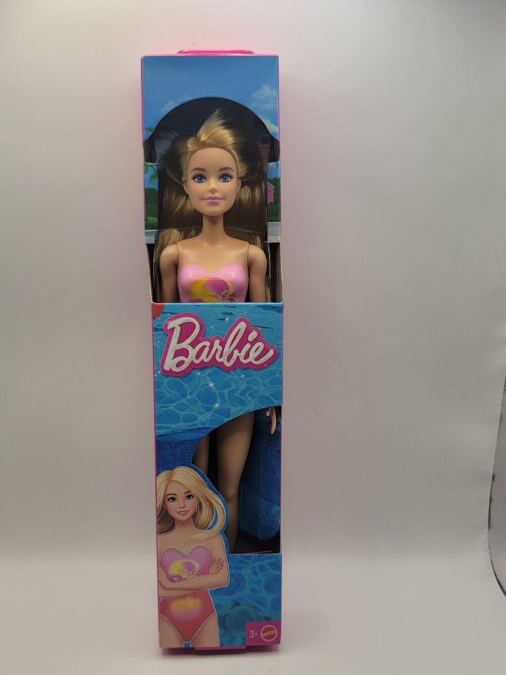 New Beach Barbie Doll with Blond Hair Wearing Pink Palm-Tree Print Swimsuit